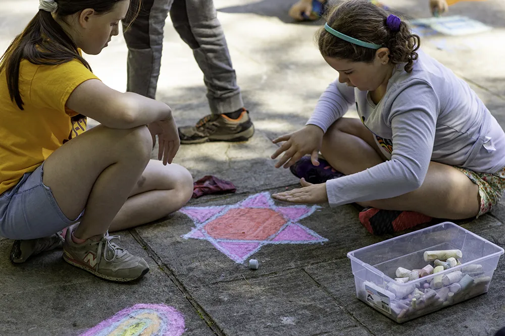 children on the playground drawing with chalk