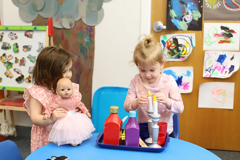 two nursery school girls playing